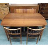 A mid 20th century dining suite comprising stained teak extending dining table, 77cm high x 135cm