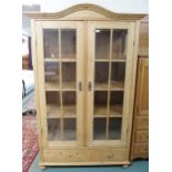 A 20th century pine two door glazed display cabinet, 199cm high x 127cm wide x 56cm deep Condition