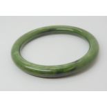 A Chinese green hardstone bangle, inner diameter 6.2cm, thickness approx 9mm, weight 41.2gms