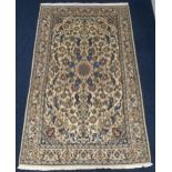 A cream ground silk inlaid Nain rug with flower head central medallion on a multicoloured floral