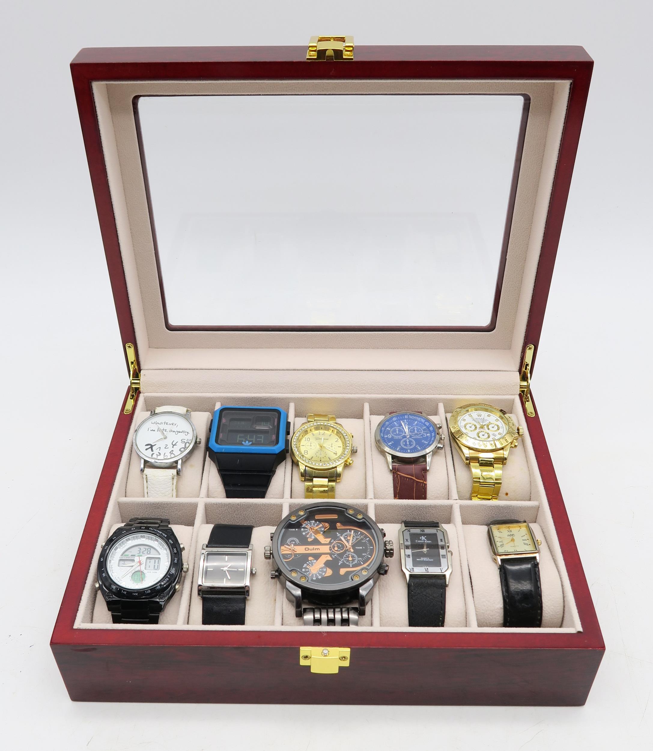 A collection of ten quartz fashion wristwatches, to include a Rolex replica and an Adidas digital
