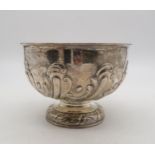 An Edwardian silver rose bowl, repousse scrolling decoration, on a footed circular base, by