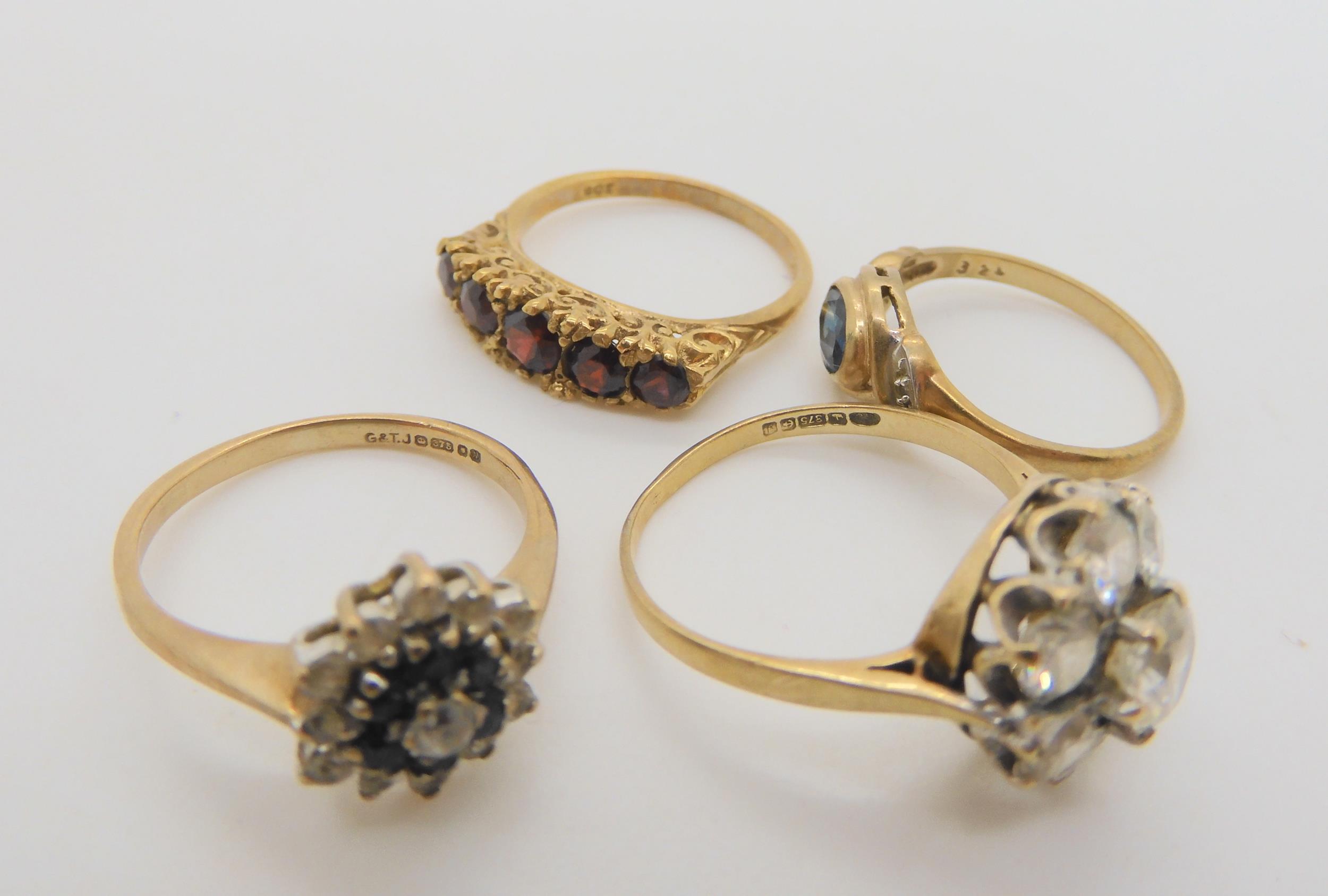 five 9ct gold gem set rings, to include a snake ring with garnet eyes, size P1/2, a five stone - Image 4 of 4