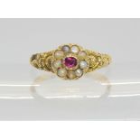 A Victorian locket ring, the hinged cover set with a ruby and pearls, with a yellow metal flower