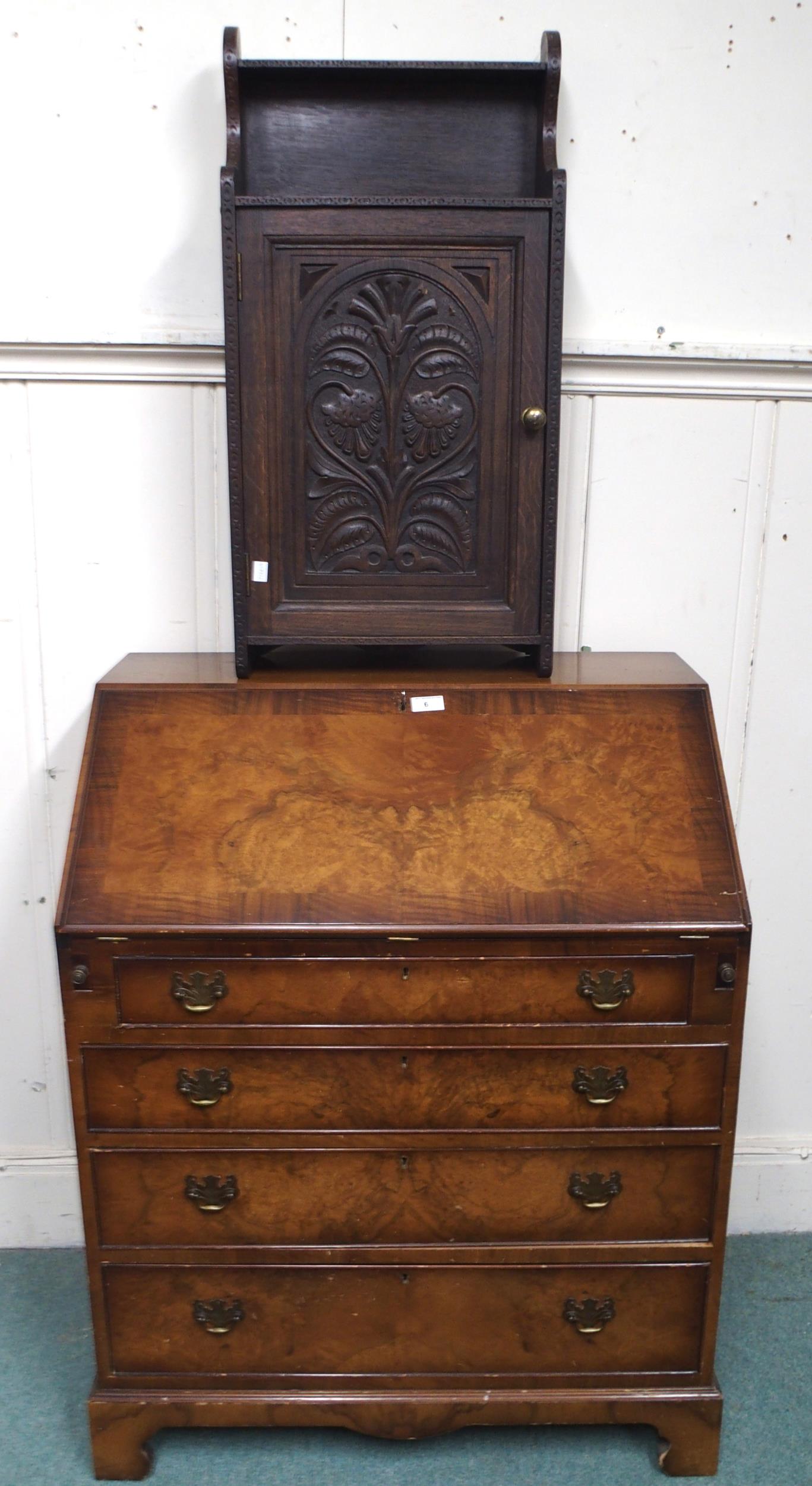 A 20th century mahogany veneered writing bureau, 97cm high x 77cm wide x 47cm deep and an oak