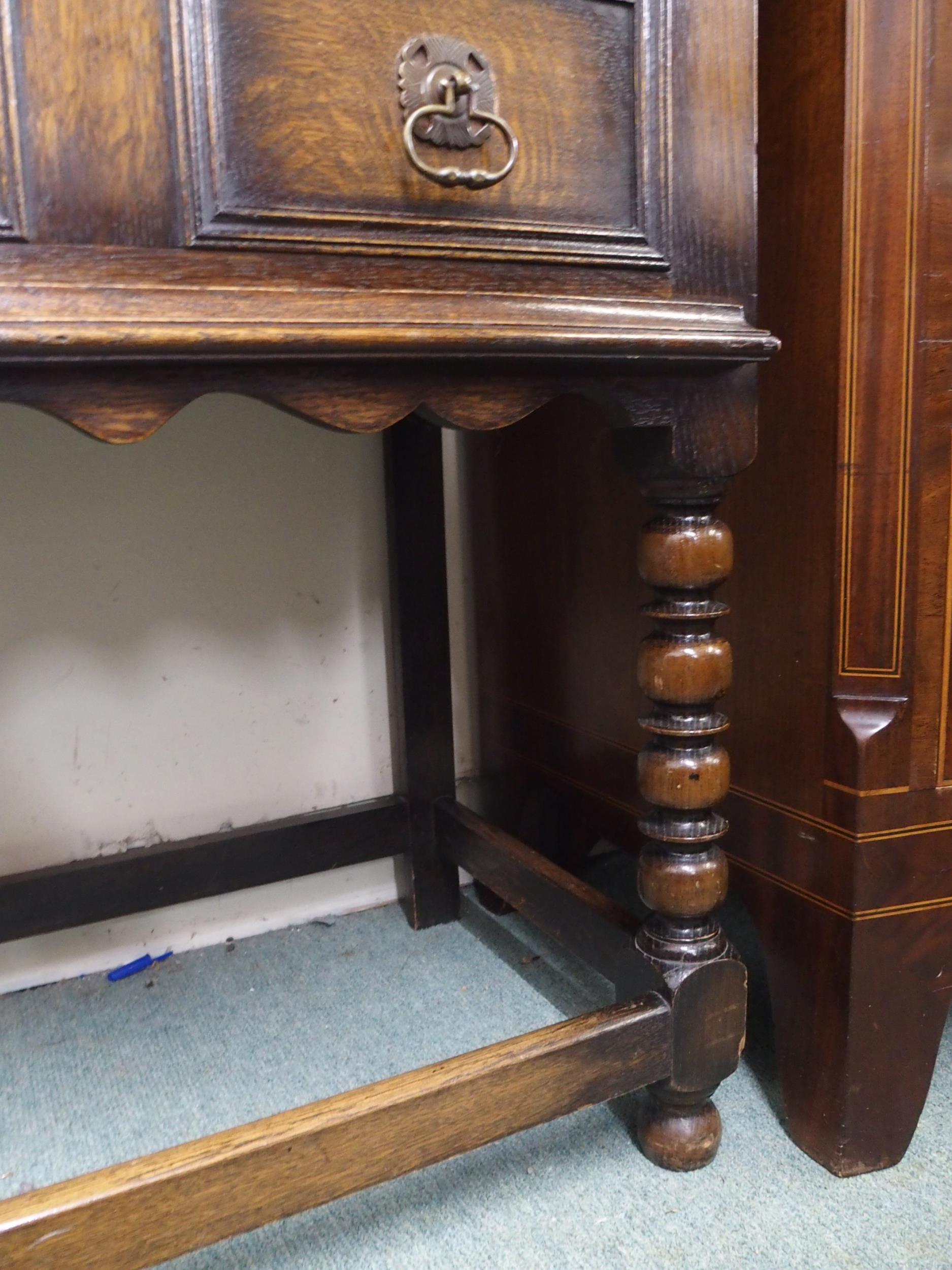 A 20th century oak baronial style two drawer buffet table on stretchered bobbin turned supports, - Image 3 of 5