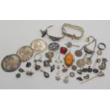 A collection of silver and white metal items to include an amethyst bangle, Arabic coin jewellery, a
