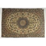 A cream ground Nain rug with multicoloured sunburst central medallion, floral patterned ground and