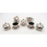 A collection of silver salts / preserve pots, including a set including a preserve pot with shell