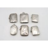 A collection of silver vestas, all with engraved scrolling foliate decoration, five with vacant