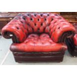 A 20th century red leather button back upholstered Chesterfield style club armchair, 69cm high x