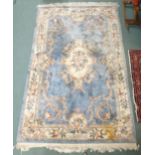 A blue ground Oriental style rug with floral central medallion and borders, 285cm long x 180cm