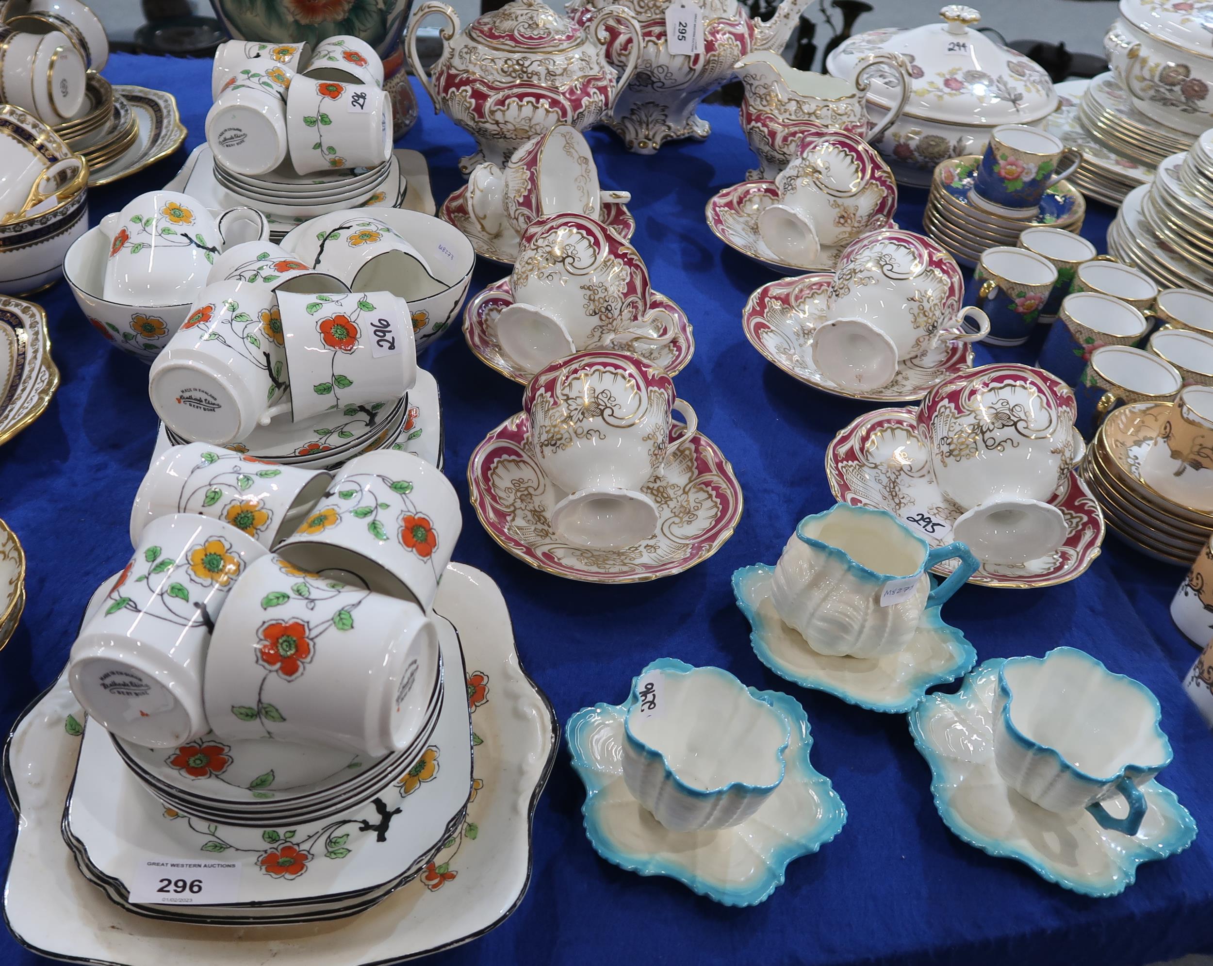 A Heathcote China teaset, decorated with yellow and orange flowers on a white ground, two shell