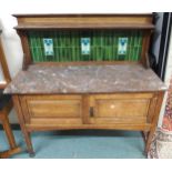 A late Victorian oak arts and crafts washstand with green tiled splashback over marble top above