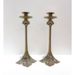 A pair of Art Nouveau style brass candlesticks Condition Report:Available upon request