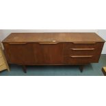 A mid 20th century teak sideboard in the manner of Austin suite with pair of cabinet doors to the