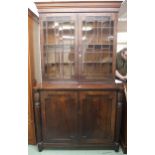 A Victorian astragal glazed bookcase with moulded cornice over pair of astragal glazed doors on