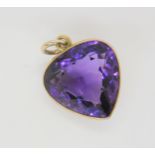 An amethyst pear shaped pendant in a yellow metal mount, length of pendant with bail 3.2cm, 6.6gms