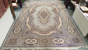 A large green ground super Keshan rug with cream central medallion, matching spandrels and