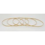 A set of five 9ct gold bangles, weight together 18.2gms Condition Report:Available upon request
