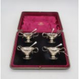 A cased set of four silver open salts, in the form of trophies, with naturalistic handles, by