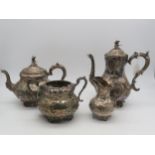 A four piece Victorian EPNS tea service, of baluster form, with embossed scrolling foliate