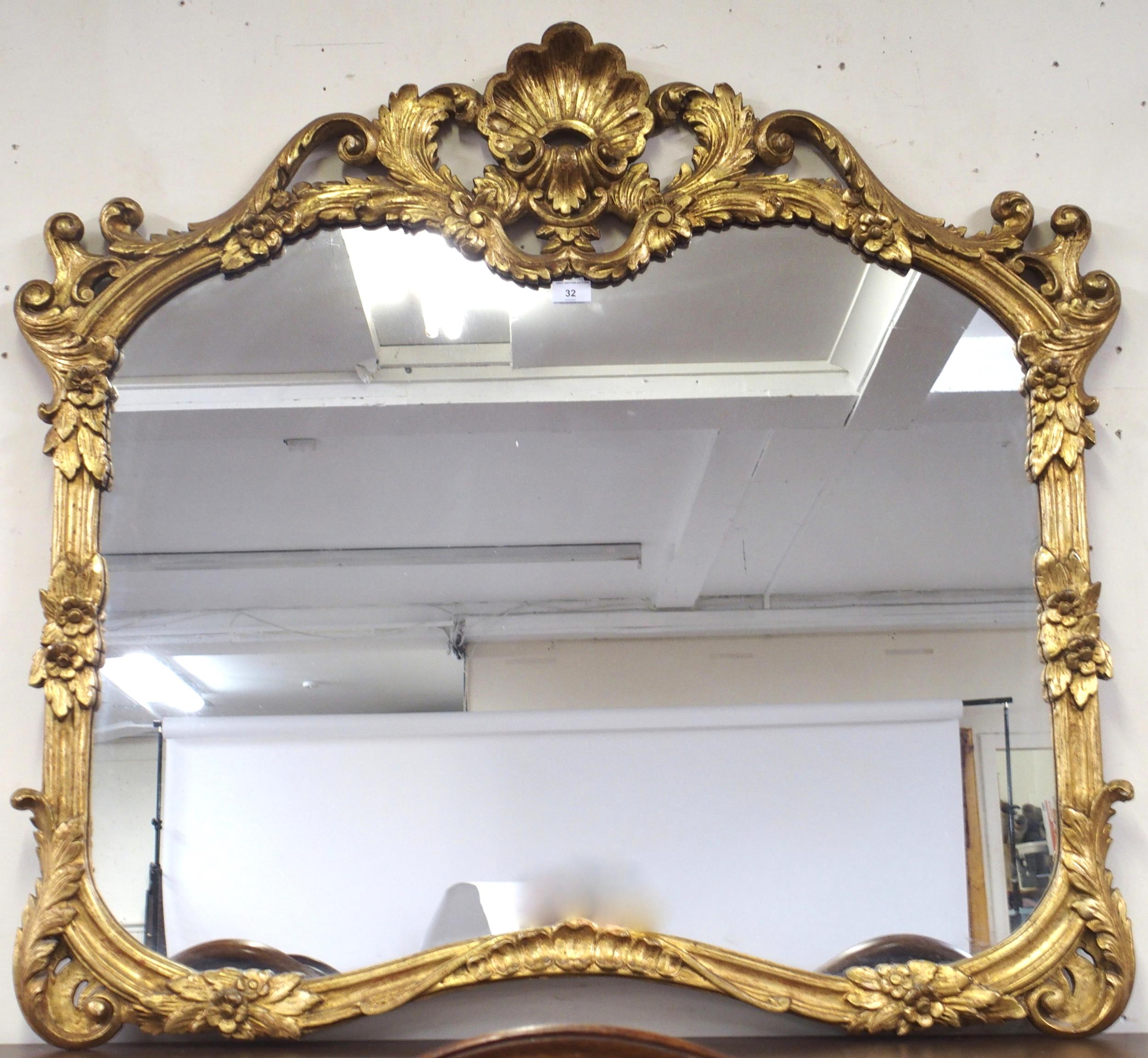 A 20th century Rococo style gilt framed overmantle mirror, 100cm high x 110cm wide Condition