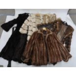 A fur gillet, a belted long black fur jacket, probably rabbit, a cream fur and suede banded coat,