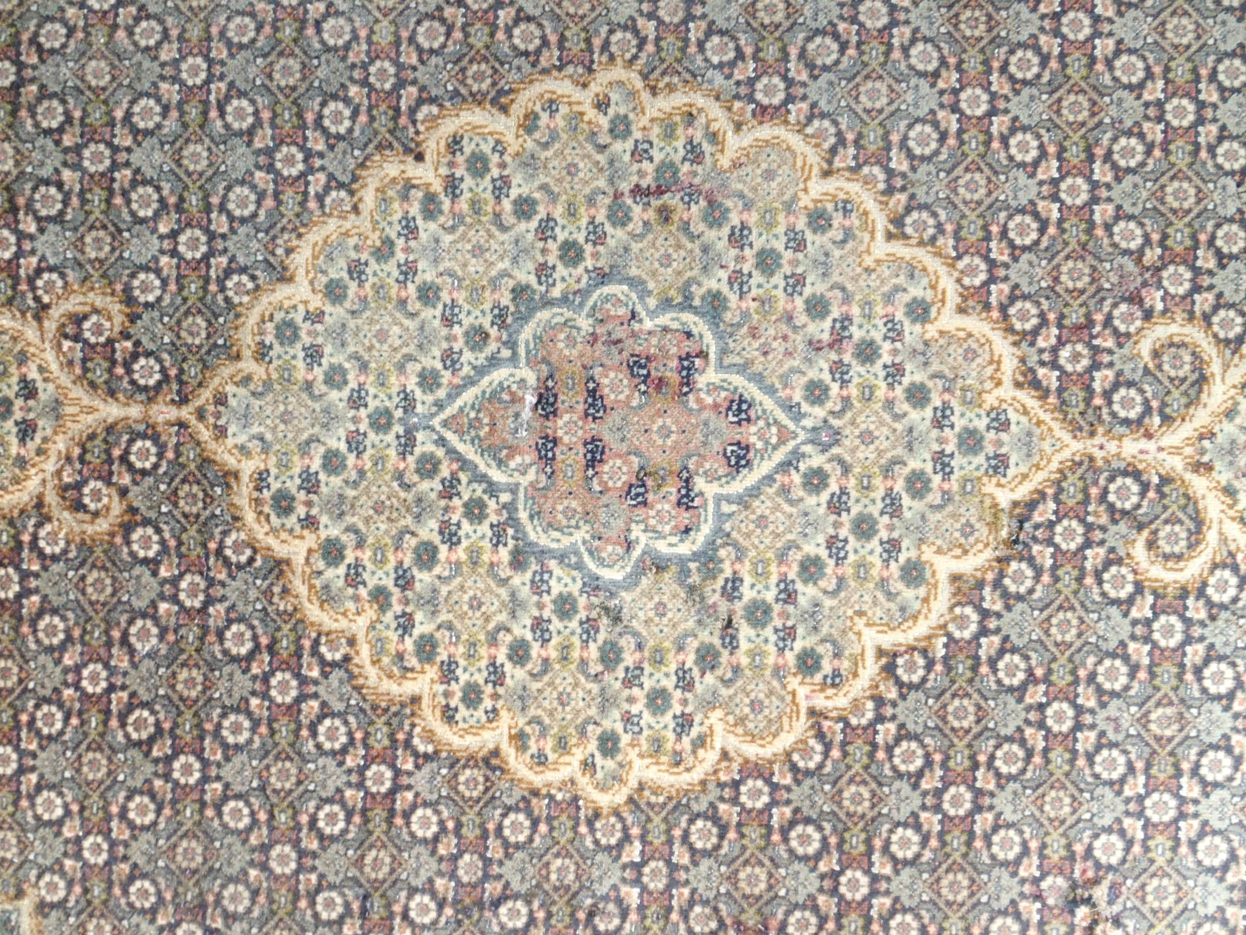 A multicoloured ground Tabriz rug with green central medallion, matching spandrels and a dark blue - Image 2 of 5