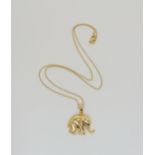 An 18ct gold elephant pendant with a diamond eye and chain, length of pendant with bail 2.3cm, chain