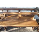 A pair ofÊearly 20th century beech bench/pews with plain back on chamfered square supports, 79cm