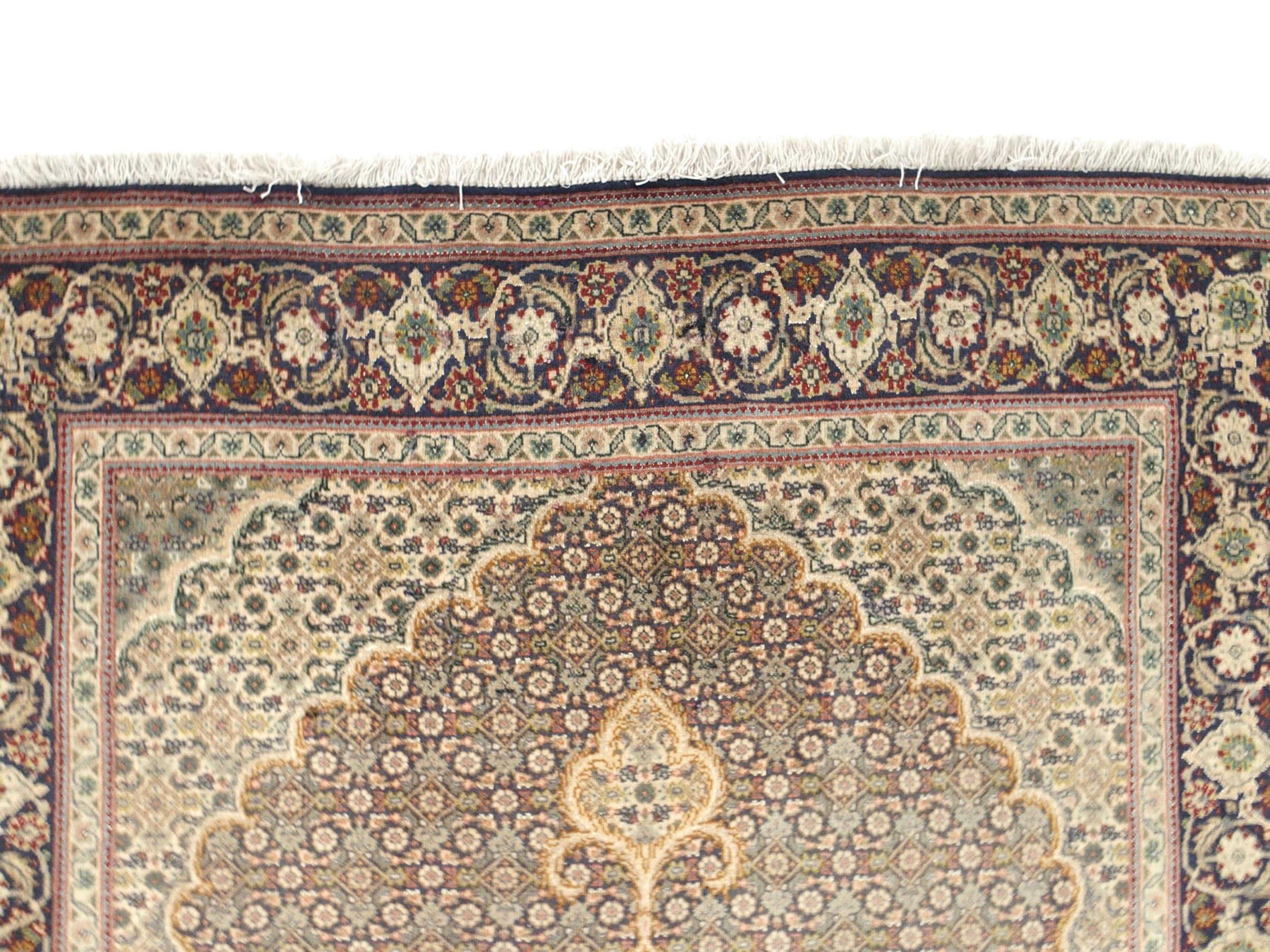 A multicoloured ground Tabriz rug with green central medallion, matching spandrels and a dark blue - Image 5 of 5