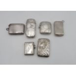 A collection of silver vestas including an embossed example, with an initialled rococo cartouche, by