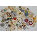 A collection of vintage brooches to include a gem set frog and other animal examples , retro