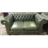 A 20th century green leather upholstered Chesterfield style two seater button back club settee on