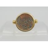 A 14k gold ring set with an 'Of the Antique coin' size approx O1/2 Condition Report:Available upon