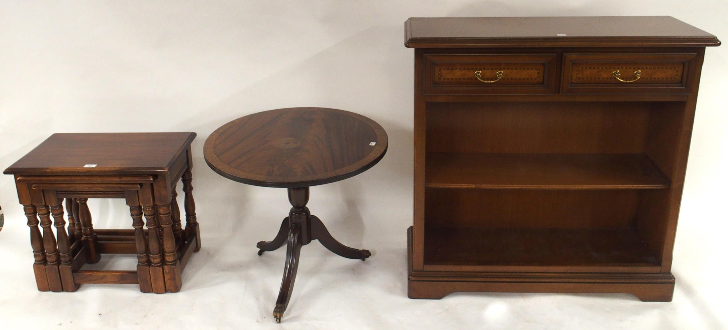 A 20th century mahogany open bookcase, oak nest of three tables and tilt top circular occasional