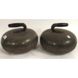 A pair of Scottish granite curling stones with ebonised wood grips set into shaped handles (2)