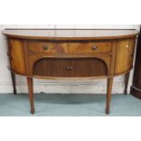 A 20th century mahogany bow front sideboard with central drawer over tambour doors flanked by