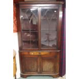 A 19th century mahogany glazed corner cabinet with moulded cornice over pair of glazed doors over