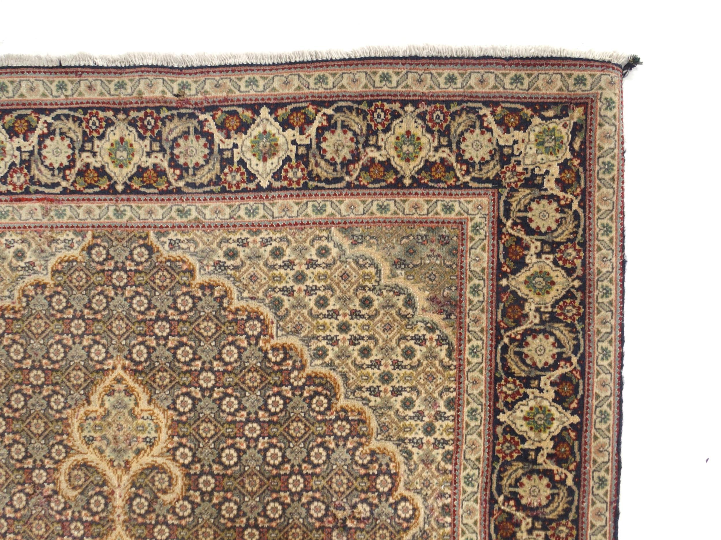 A multicoloured ground Tabriz rug with green central medallion, matching spandrels and a dark blue - Image 3 of 5