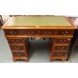 A 20th century mahogany twin pedestal writing desk with green writing skiver over central long