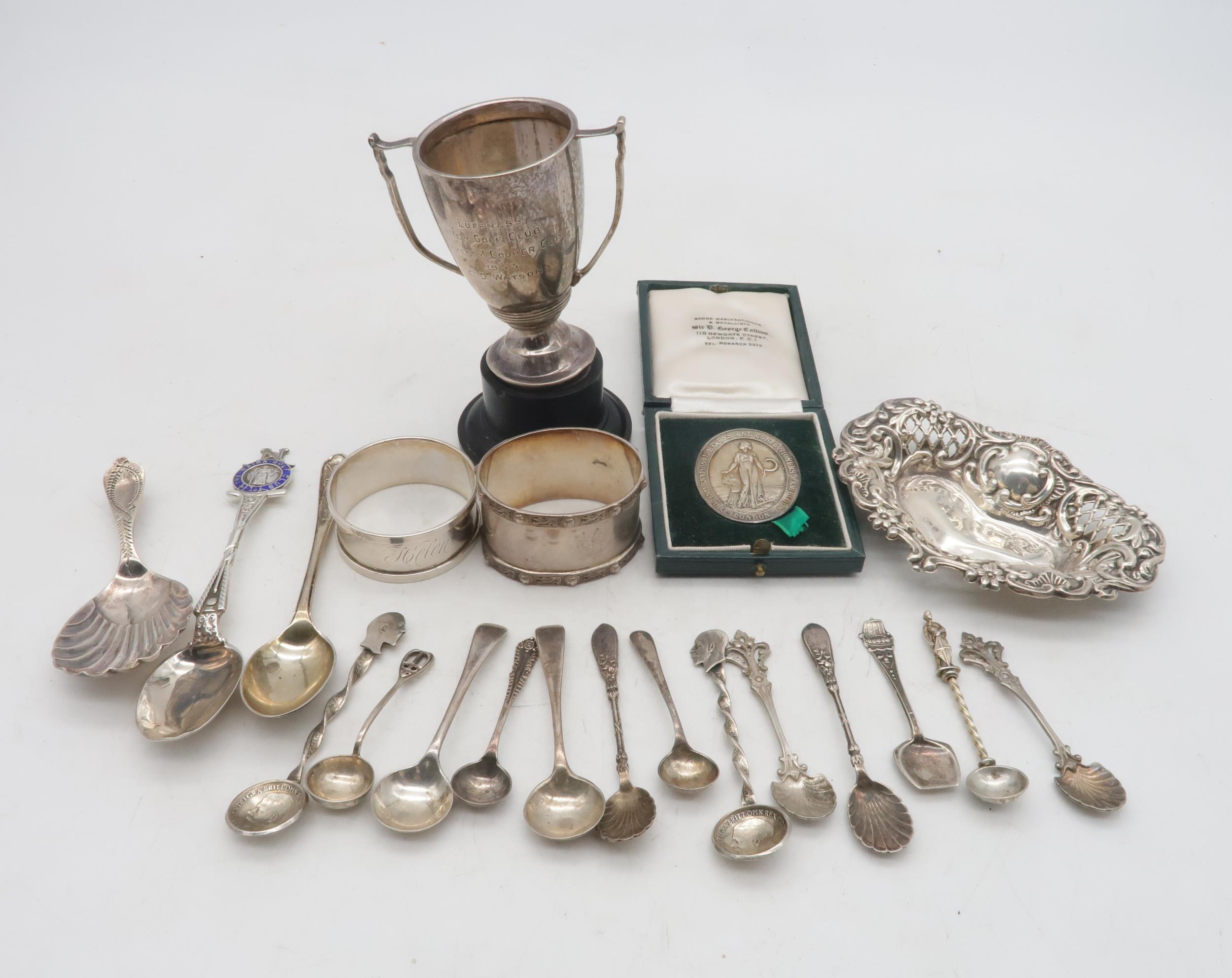 A collection of silver including a miniature silver trophy cup, on a turned plastic base, by