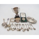 A collection of silver including a miniature silver trophy cup, on a turned plastic base, by