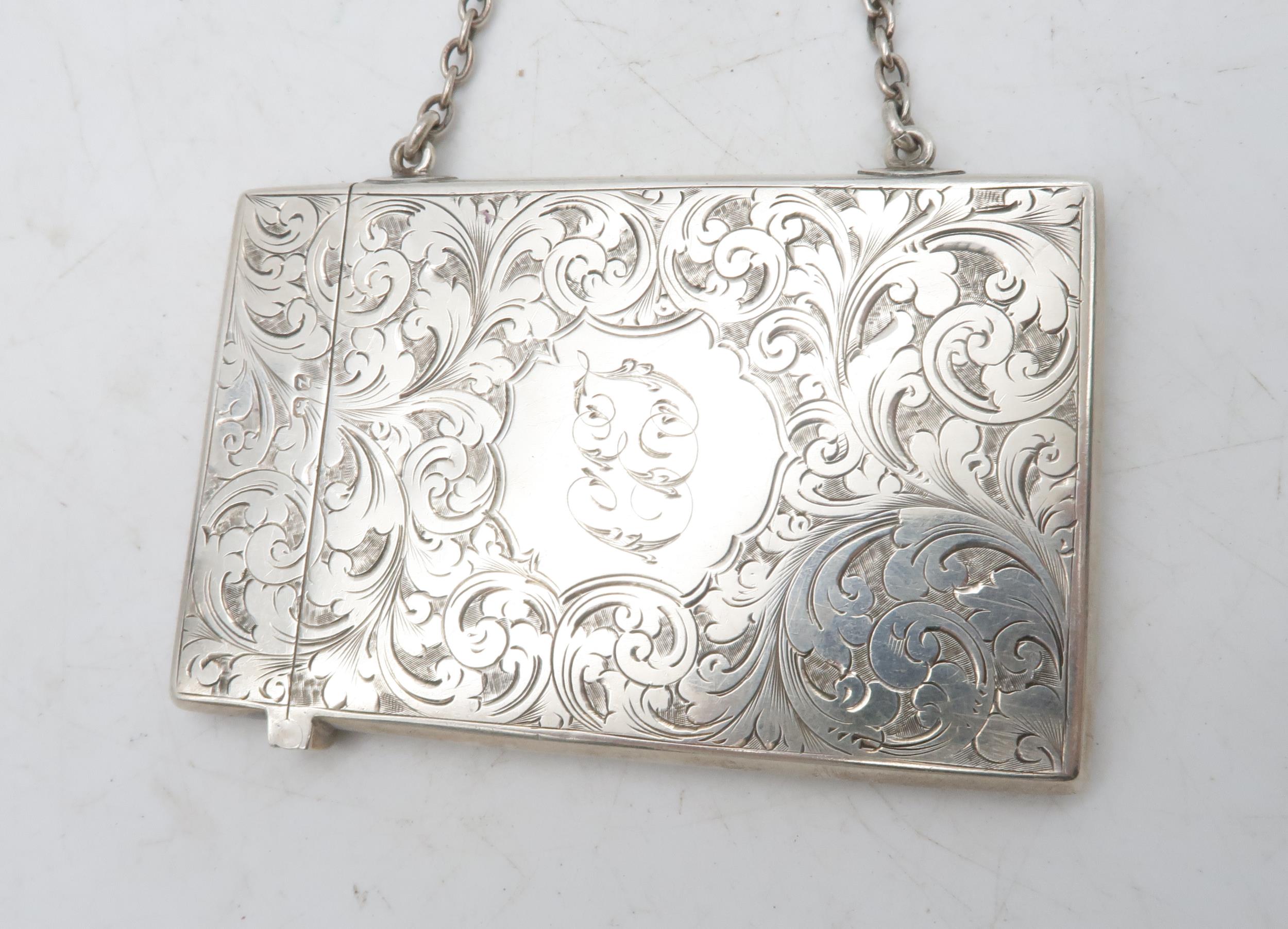 A late Victorian silver card case, the body engraved with scrolling foliate decoration surrounding a - Image 2 of 3