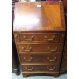 A 20th century mahogany writing bureau with fall front writing compartment over four drawers on