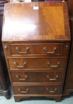 A 20th century mahogany writing bureau with fall front writing compartment over four drawers on
