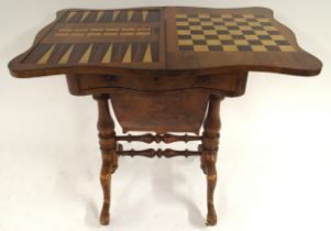 A Victorian walnut and satinwood inlaid fold over games table with serpentine fold over top