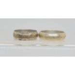 Two 9ct white gold wedding rings, heavy 'D' shape size O, zig zag engraved size M, weight together