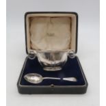 A matched Edwardian cased silver christening bowl set, the bowl with two loop handles, by John